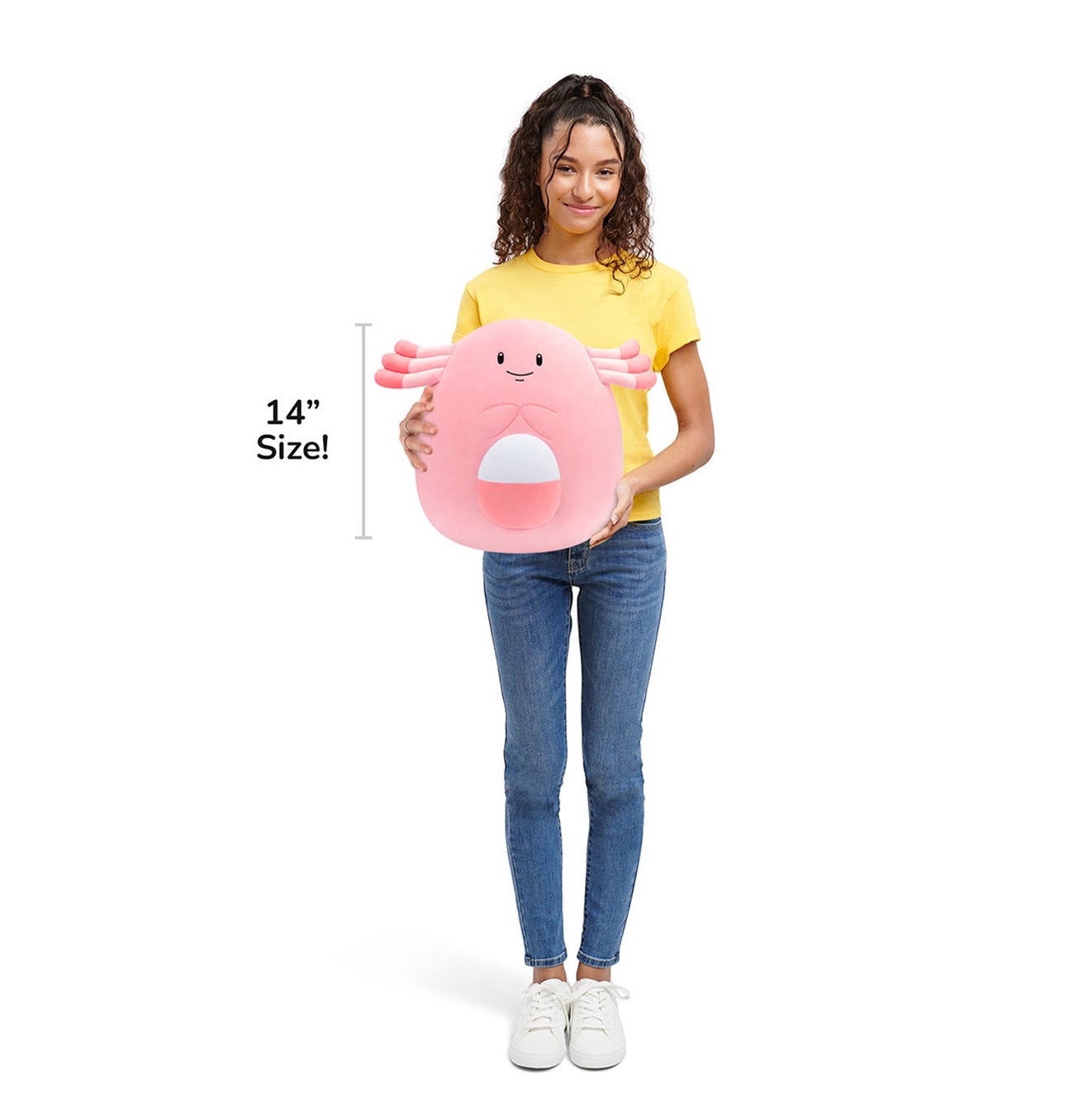 Person holding a pink plush toy with text indicating size on a white background